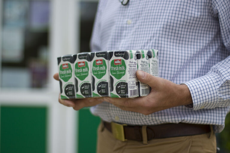Milk in 189ml cartons being carried to class.