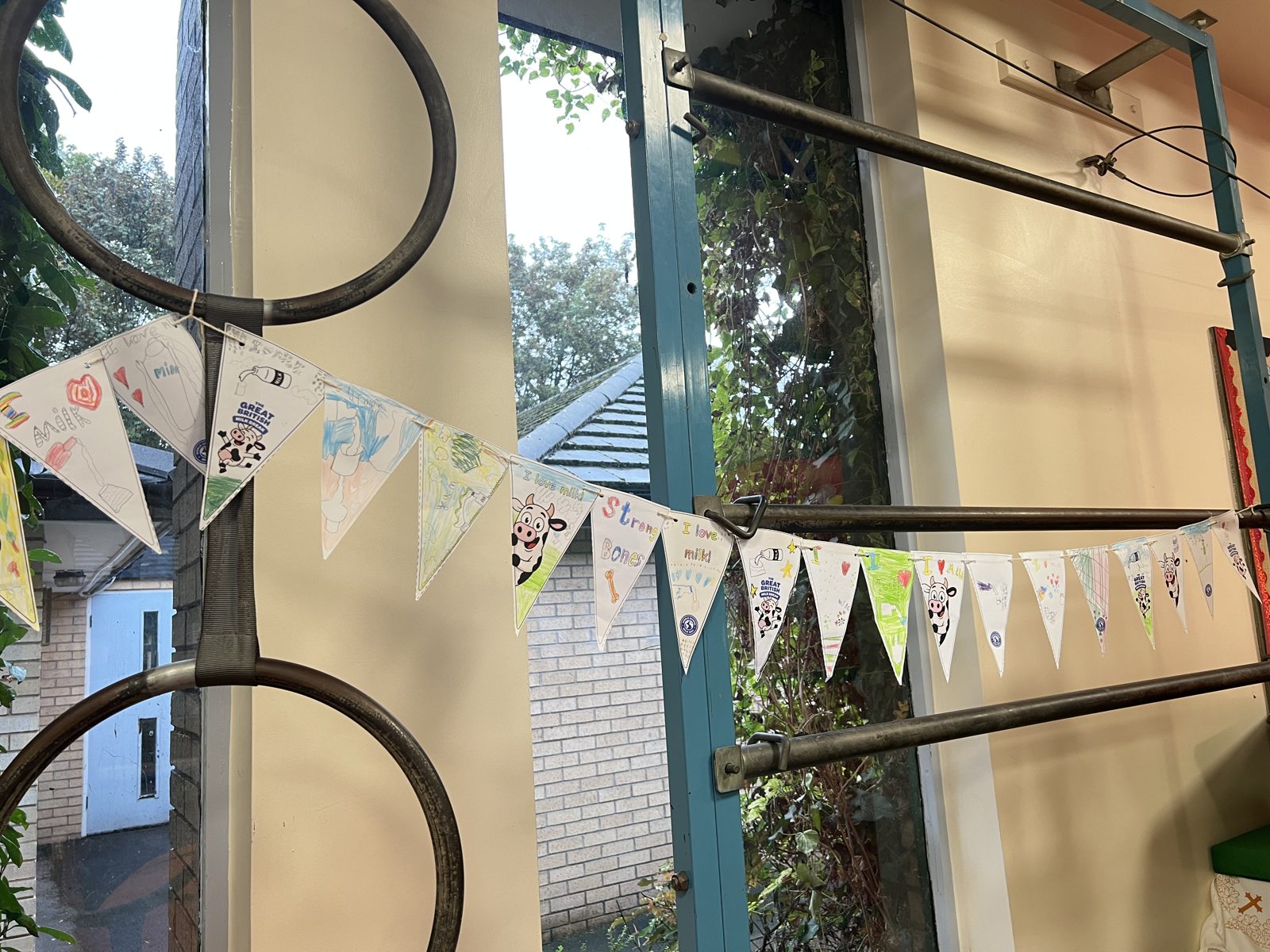 Pupil-decorated Great British Milk Break bunting with messages like 'I love milk' and 'Strong bones'